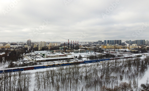 View from the height of the winter city with buildings and transport © Payllik