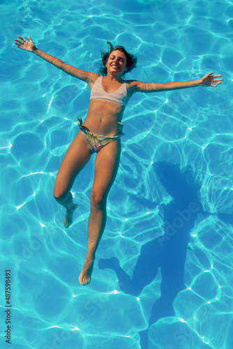 Woman floating on water while on summer vacation
