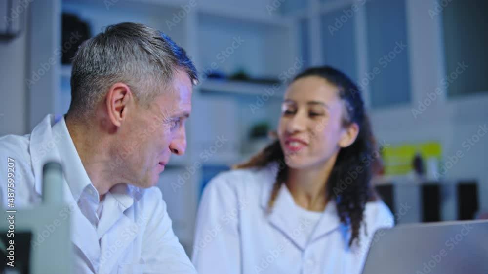 Happy medical laboratory scientists giving high five, discover disease treatment Happy medical laboratory scientists giving high five, discover disease treatment