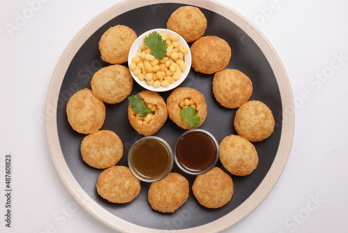 Tadeonal subcontinental street snack food boondi chickpeas potato Dahi Puri Chaat pani puri fuska set with chutny sauce