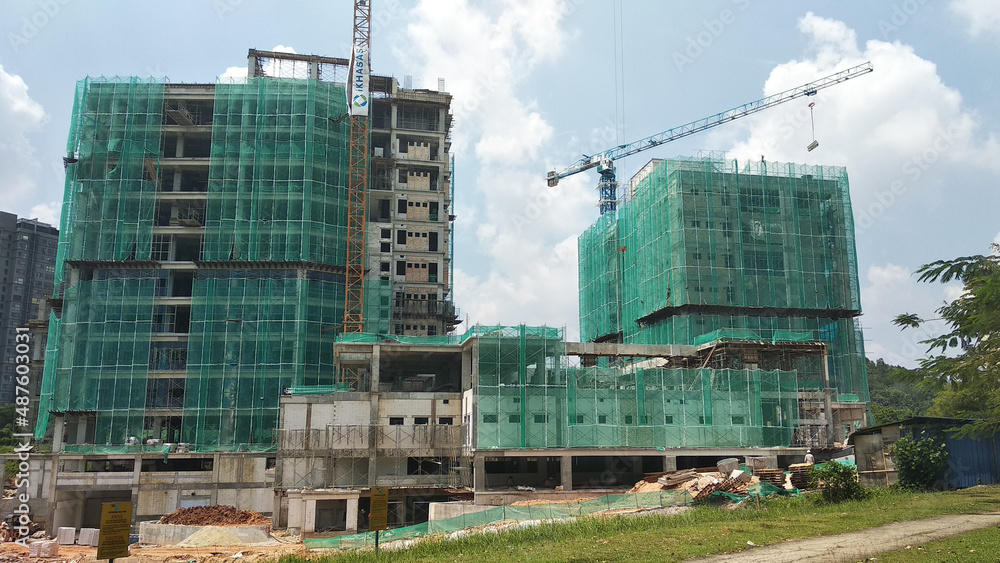 SELANGOR, MALAYSIA - 5 MARCH 2021: A high-rise building complex is under construction. Works are carried out under strict safety & security supervision. 