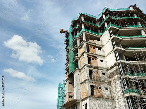SELANGOR, MALAYSIA - 5 MARCH 2021: A high-rise building complex is under construction. Works are carried out under strict safety & security supervision. 
