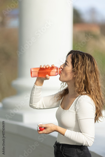 Woman drinking water on street