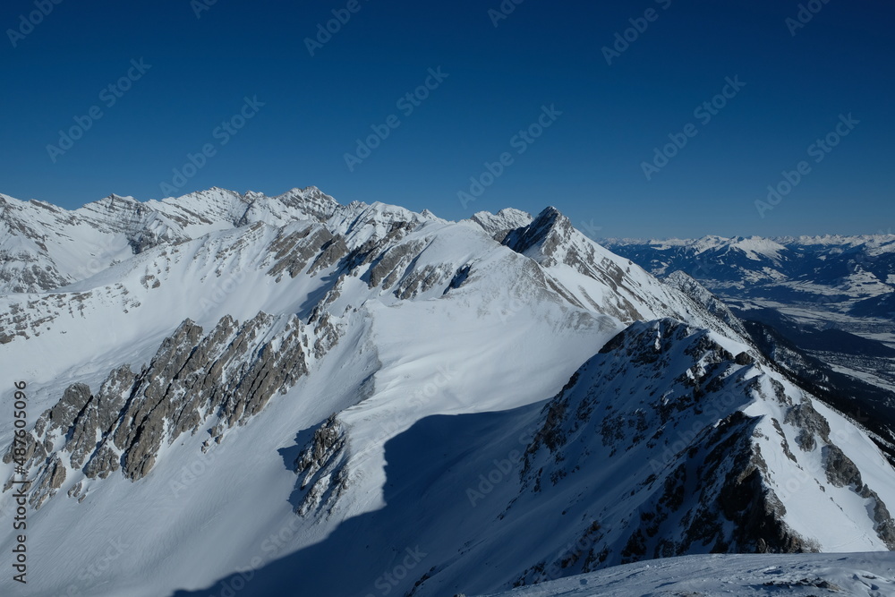 Snowy mountain top on Top of Innsbruck with blue sky in the background. Nordkette, Innsbruck