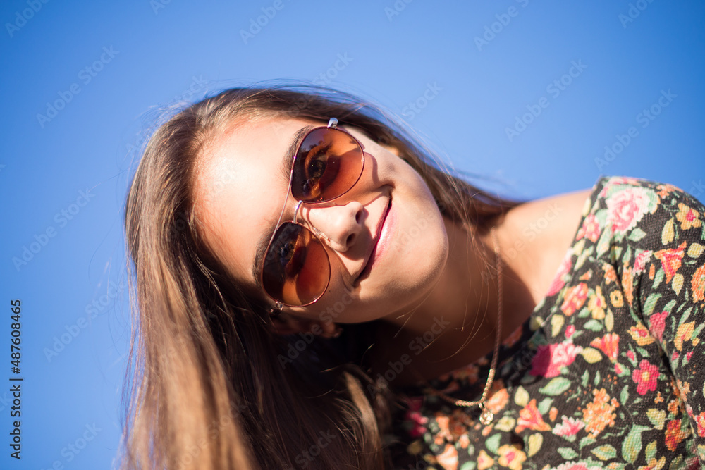 portrait of a beautiful girl in sunglasses against the sky. girl on the beach. Portrait of a girl traveler. Travel and freedom. Girl in spring. smiling young woman portrait of a beautiful girl in sunglasses against the sky. girl on the beach. Portrait of a girl traveler. Travel and freedom. Girl in spring. smiling young woman