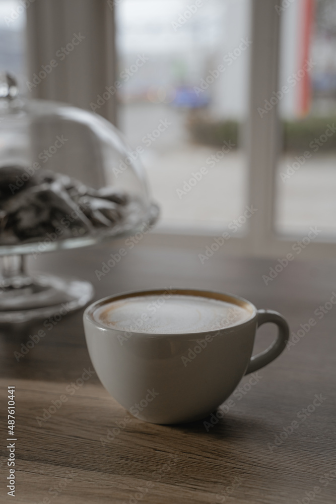 a cup of cappuccino is on the table a cup of cappuccino is on the table