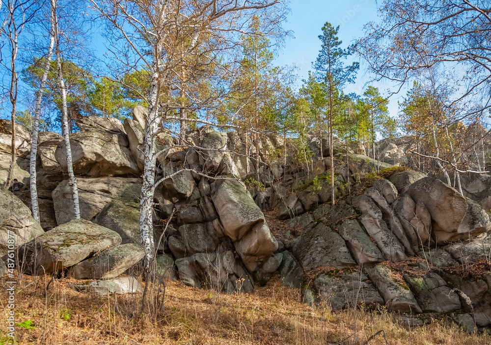 Autumn landscape with trees and rocks on top of a mountain against the sky Autumn landscape with trees and rocks on top of a mountain against the sky