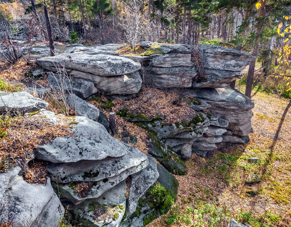 Autumn landscape with trees and rocks on top of a mountain against the sky Autumn landscape with trees and rocks on top of a mountain against the sky