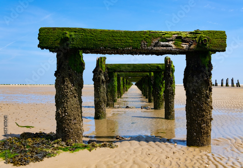 Old Harbour on the Beach of Wangerooge Island. Landing stage, rooten pier in National Park and World Heritage “Wattenmeer“ North Sea Ostfriesland Germany. Weathered wooden structure in natural reserve photo