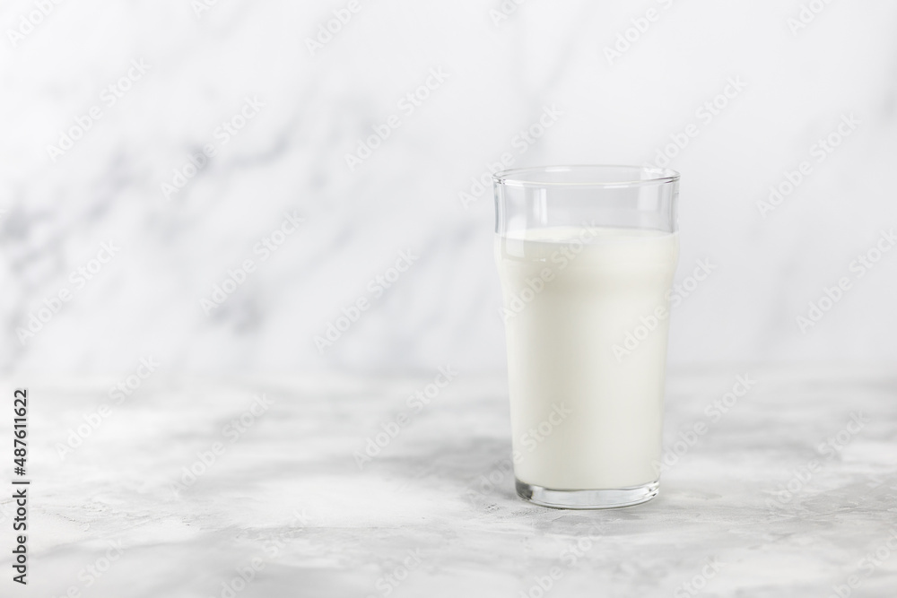 A glass of kefir on a concrete table with a bridge for copying.. A glass of kefir on a concrete table with a bridge for copying..