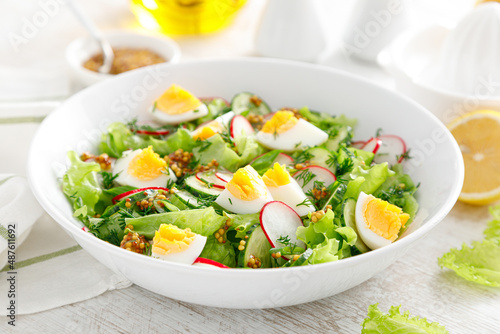 Cuadro en lienzo Easter fresh vegetable salad with boiled egg, radish and cucumber, dressing with