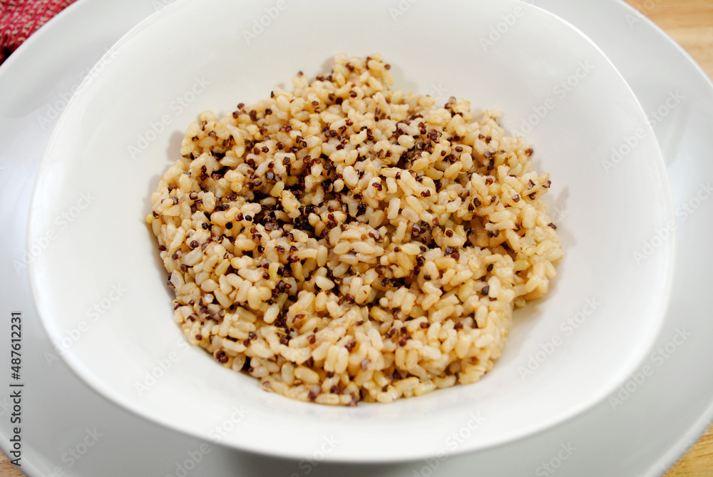 A Side Dish of Steamed Quinoa and Brown Rice in a White Bowl A Side Dish of Steamed Quinoa and Brown Rice in a White Bowl