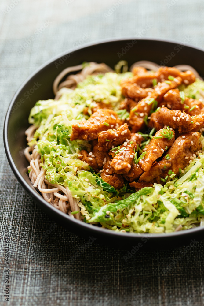 Spicy soy curls on shredded savoy cabbage, served with buckwheat noodles. Spicy soy curls on shredded savoy cabbage, served with buckwheat noodles.