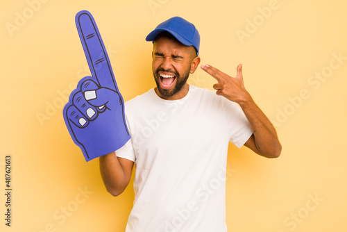 black afro man looking unhappy and stressed, suicide gesture making gun sign. number one hand concept. number one hand concept