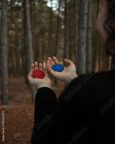 Obraz na plátne Person woman holding magnets for biomagnetism in the forest