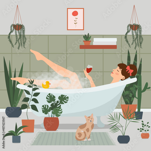 The girl takes a bath with foam, and holds a glass of wine in her hand. Surrounded by potted plants. A woman is relaxing in the bath. Bathroom interior.