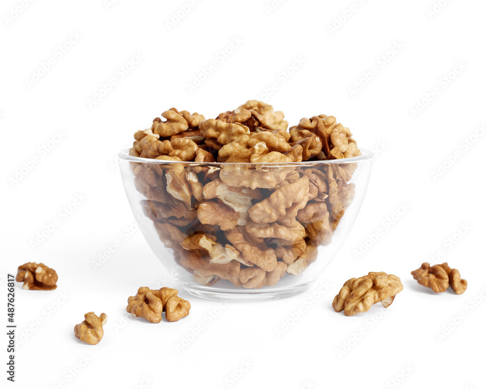Peeled walnuts in a glass bowl. Isolated on white background Peeled walnuts in a glass bowl. Isolated on white background