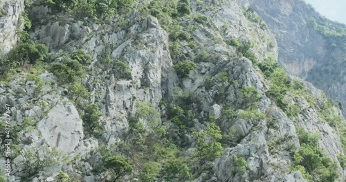 Flying around rocky mountains Balkan Peninsula in summer. Mountain stone texture. Beautiful view of stone mountains. Grand canyon in Europe. Scenic tourism. Slow motion. 4k footage background