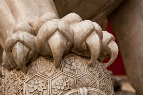 Paw and claws of a Marble sculpture of male lion, one of traditional guardian pair at Jingshan Park gate. Beijing, China photo