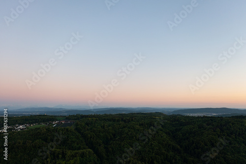 Wallpaper Mural Amazing shot of a beautiful landscape in the alps of Switzerland. Wonderful flight with a drone over an amazing landscape in the canton of Aargau. Epic view at sunset over a village called Nussbaumen. Torontodigital.ca