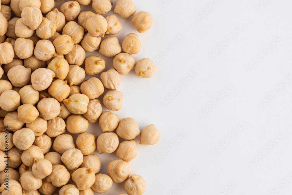Food background with a layer of chickpeas on white