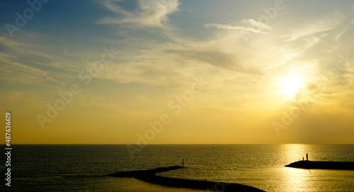 Sunset over Italian town San Vincenzo with statue of the Sailor