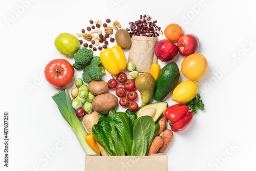 Fototapeta Naklejka Na Ścianę i Meble -  Healthy food background. Healthy food in paper bag vegetables and fruits on white. Shopping food supermarket concept. Food delivery, groceries, vegan, vegetarian eating. Top view