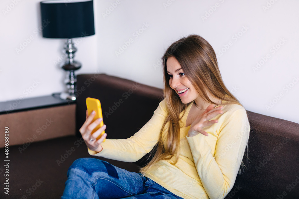 Young woman spending free time home. Self care, staying home. Videochatting with friends. Quarantined person indoors. Avoiding social contact. Young woman spending free time home. Self care, staying home. Videochatting with friends. Quarantined person indoors. Avoiding social contact.