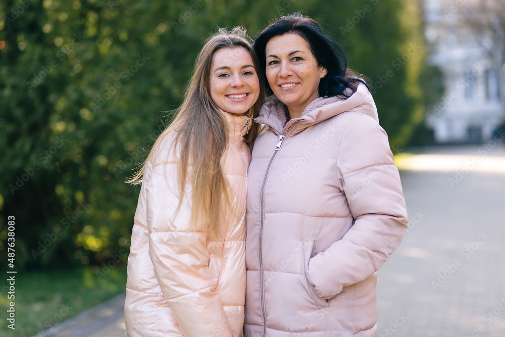 Teenage daughter having a great time with mother, outdoors. Teenage daughter having a great time with mother, outdoors.
