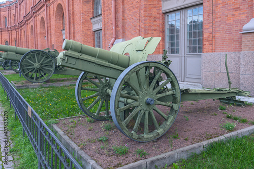 An ancient iron cannon on wheels located in the museum of weapons of the Russian city of St. Petersburg