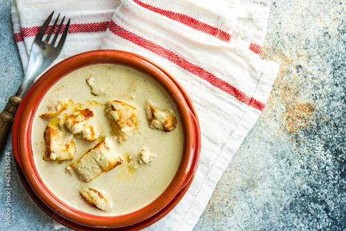 Overhead view of a bowl of Georgian chicken in walnut sauce (Chicken Bazhe) photo