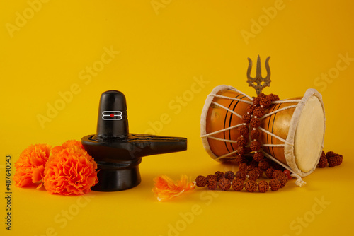 Happy Maha Shivaratri greeting card - Shiva Linga decorated with flowers, trishula, and damru. Hindu festival celebrated of Shiva Lord photo