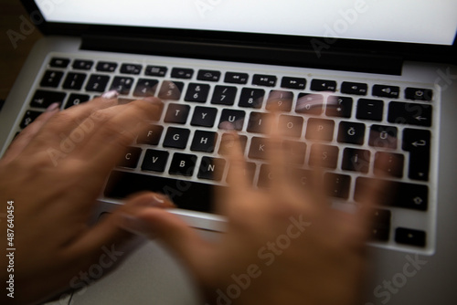 hand typing on computer keyboard