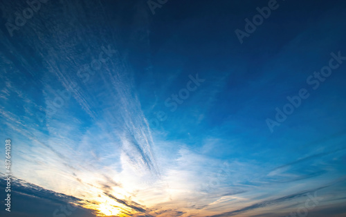 blue sky with spindrift clouds at sunset photo