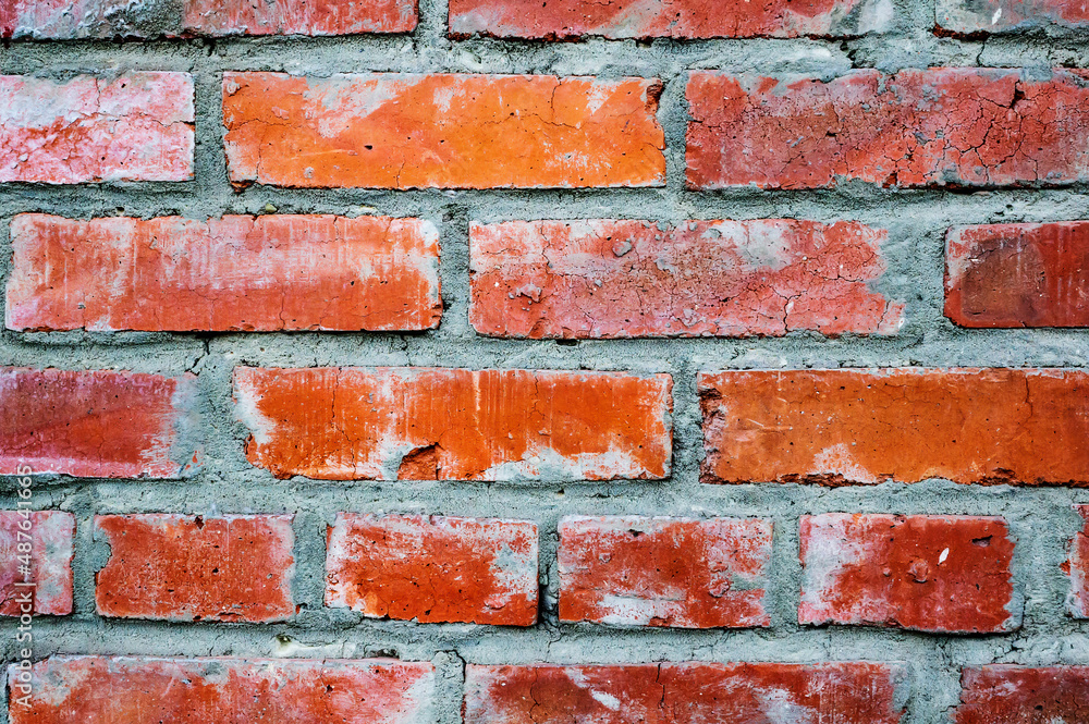 An old authentic brick wall with antique brickwork. Uneven defective brickwork. Background for the designer An old authentic brick wall with antique brickwork. Uneven defective brickwork. Background for the designer