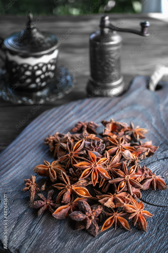 Fresh organic fruits and spice seeds from star anise with a spice grinder. Organic dry star anise. aniseed stars on a dark rustic background Fresh organic fruits and spice seeds from star anise with a spice grinder. Organic dry star anise. aniseed stars on a dark rustic background