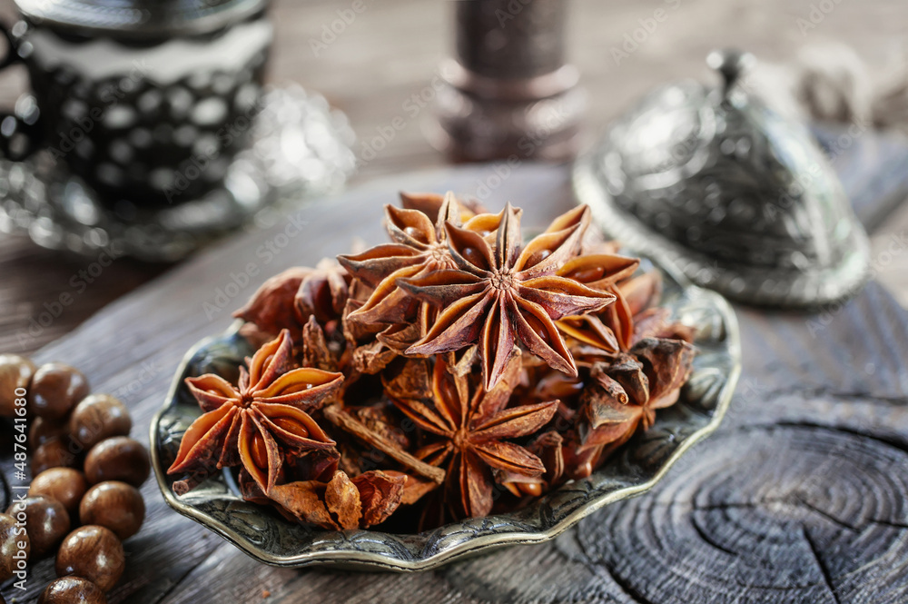 Fresh organic fruits and spice seeds from star anise . Still life in Arabic style. Organic dry star anise. aniseed stars on a dark rustic background Fresh organic fruits and spice seeds from star anise . Still life in Arabic style. Organic dry star anise. aniseed stars on a dark rustic background