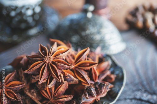 Fresh organic fruits and spice seeds from star anise . Still life in Arabic style. Organic dry star anise. aniseed stars on a dark rustic background photo