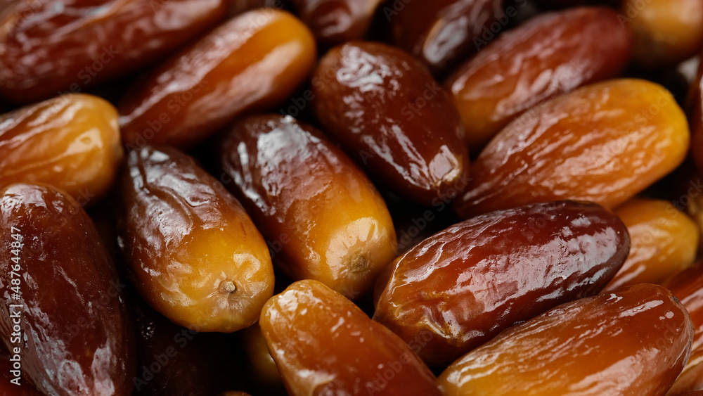 Fresh dates fruits close up. Eating dried fruits. Vegan, vegetarian food Fresh dates fruits close up. Eating dried fruits. Vegan, vegetarian food