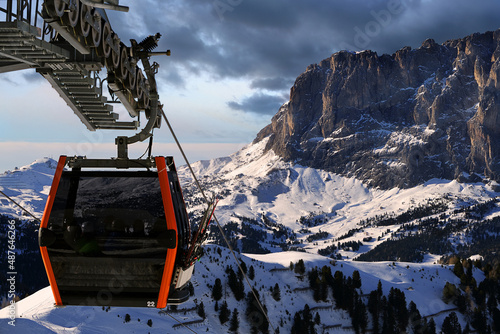 High alpine peaks covered in snow in the afternoon light with slightly out of focus cable car in the foreground