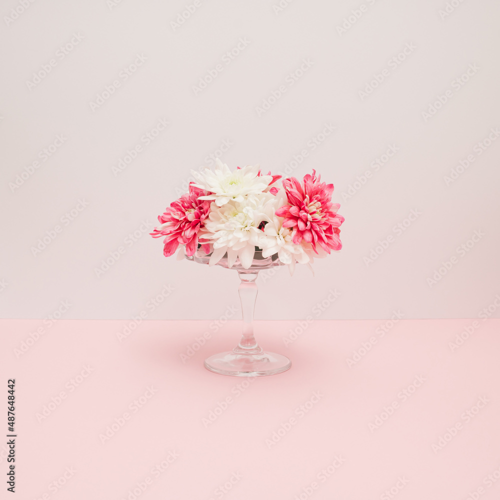 Beautiful pink and white flowers in a cake holder. Holiday minimal concept.