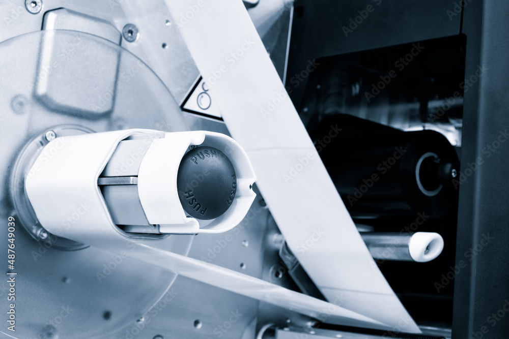 Fragment of the conveyor of sticking labeling machine. Abstract industrial background. Fragment of the conveyor of sticking labeling machine. Abstract industrial background.