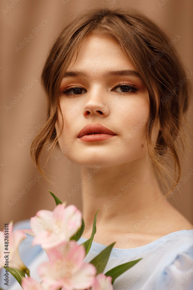 a girl in a blue dress with flowers in her hands a girl in a blue dress with flowers in her hands