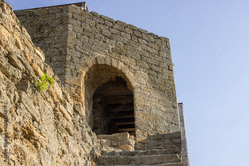 Holes for medieval guns in a defensive fortress. Space for protection in stone walls. The point of warfare in the citadels. Details of architecture.