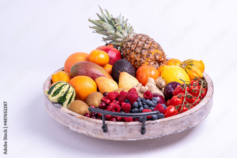 fresh vegetables and fruits isolated on a white background in wooden tray. fresh vegetables and fruits isolated on a white background in wooden tray.