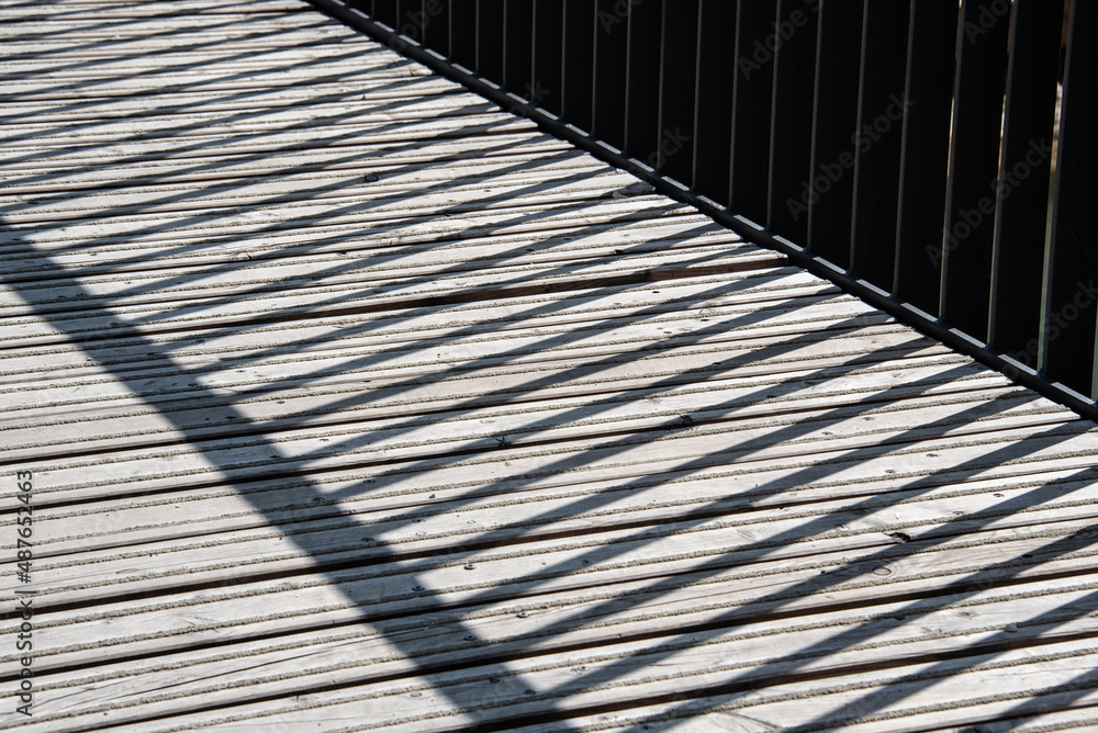 shadow of the railing on a bridge shadow of the railing on a bridge