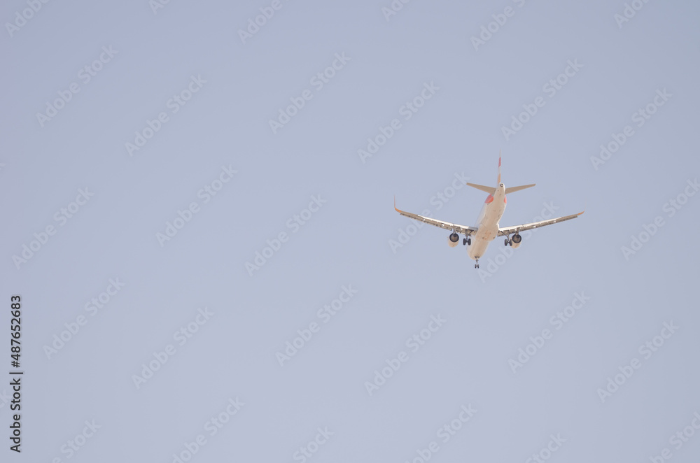 Underside view of an airplane in flight. Aguimes. Gran Canaria. Canary Islands. Spain. Underside view of an airplane in flight. Aguimes. Gran Canaria. Canary Islands. Spain.