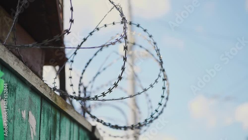 Barbed wire. Prison fence. View at the barb wall of the crime area or closed military camp. Security, Protection and Exclusion.