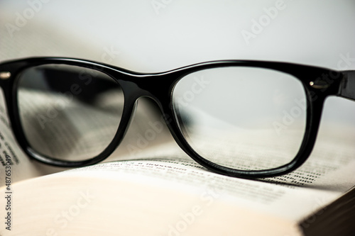 Clear glasses on a background of a set of books. Literature, learning concept