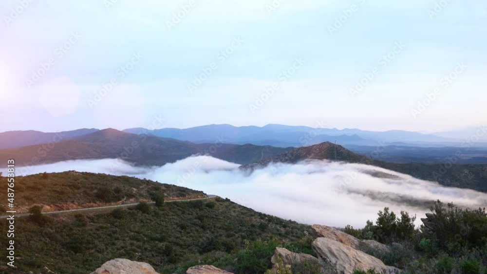 clouds fly fast over the mountain in the valley at sunset on a spring day in northern spain clouds fly fast over the mountain in the valley at sunset on a spring day in northern spain